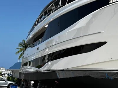 Three decks of a large white yacht polished to a mirror